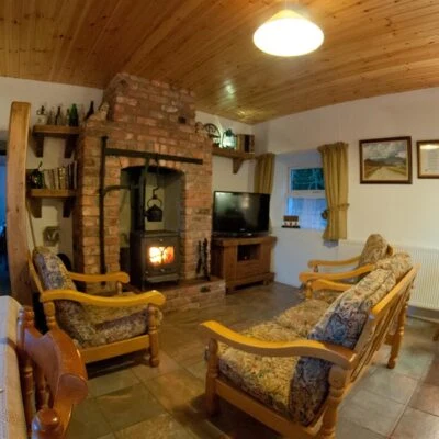 Cobblers Cottage - relaxing area with fire place and tv