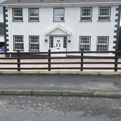Redory House - Exterior front view of detached 2 storey dwelling with paved private parking area set back from pavement and road.