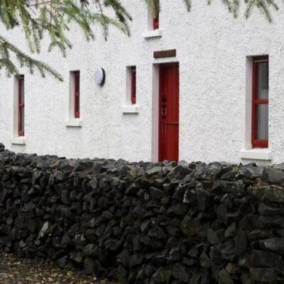 An Creagán (3 bedroom) – Copney - Back of the house with red door and brick wall